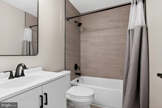 a bedroom with a bed couch and a window