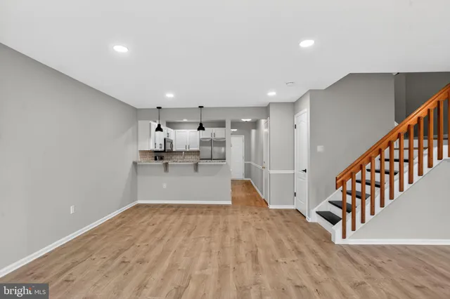a view of kitchen with refrigerator and window