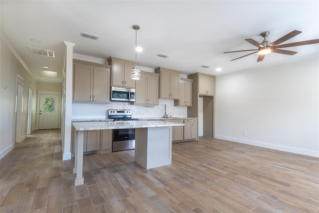 412 Crosby Street Lindale, TX 75771 - Photo 11 of 36 a view of kitchen with sink microwave and refrigerator