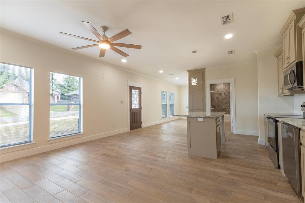 412 Crosby Street Lindale, TX 75771 - Photo 15 of 36 a view of an empty room with window and cabinet
