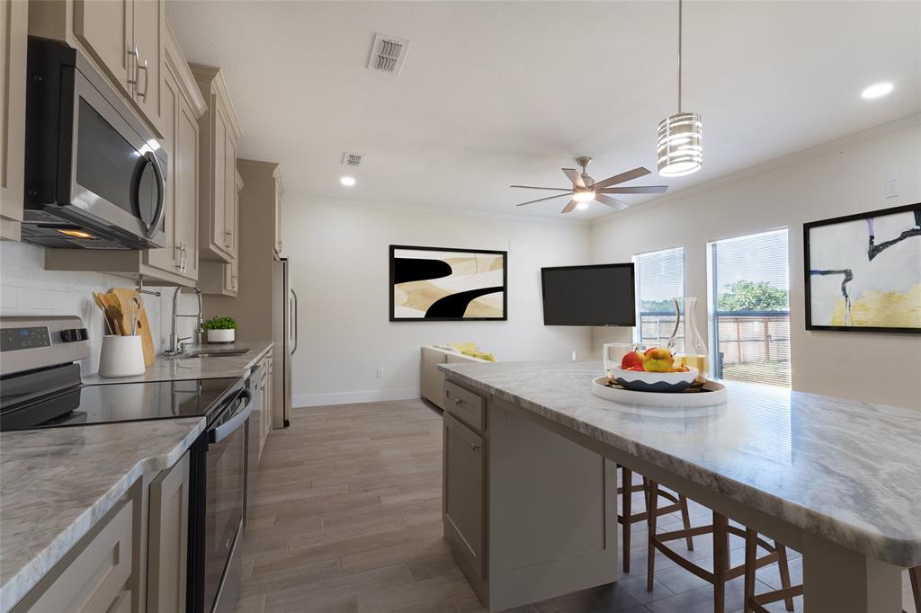 412 Crosby Street Lindale, TX 75771 - Photo 19 of 36 a kitchen with stainless steel appliances granite countertop a sink a stove and a wooden cabinets