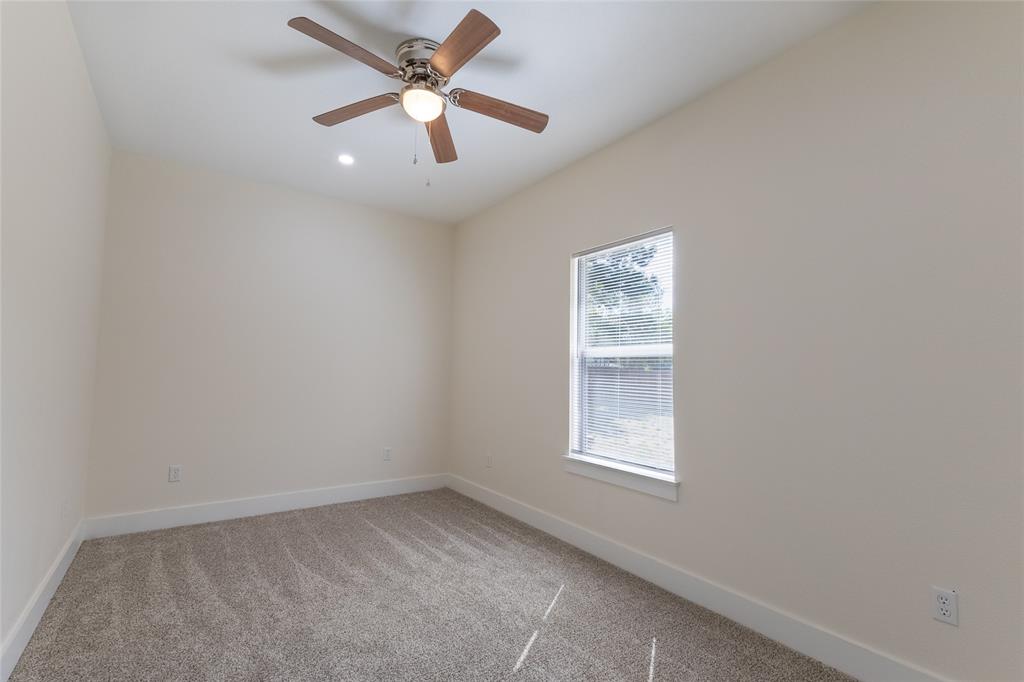 412 Crosby Street Lindale, TX 75771 - Photo 27 of 36 an empty room with a window and a fan