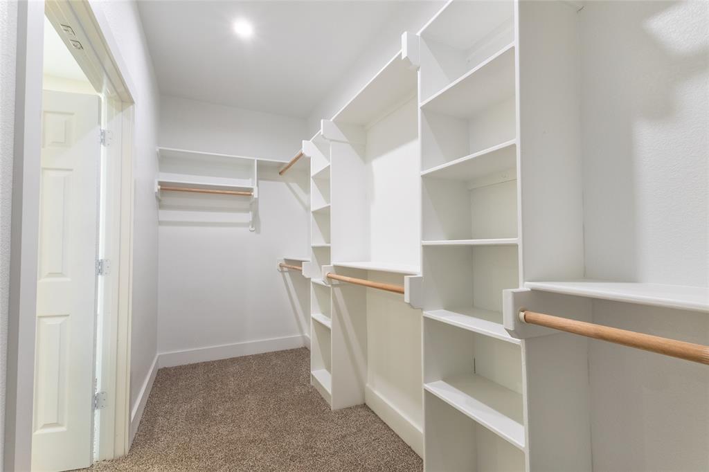 412 Crosby Street Lindale, TX 75771 - Photo 29 of 36 a view of walk in closet with empty racks