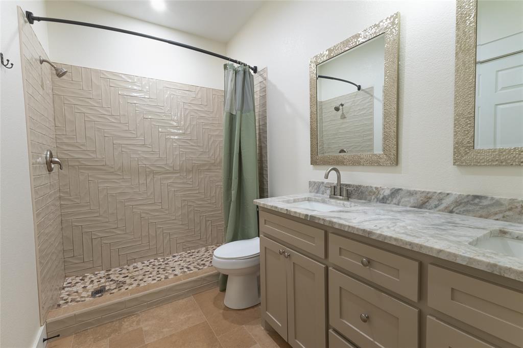 412 Crosby Street Lindale, TX 75771 - Photo 30 of 36 a bathroom with a granite countertop sink toilet and shower
