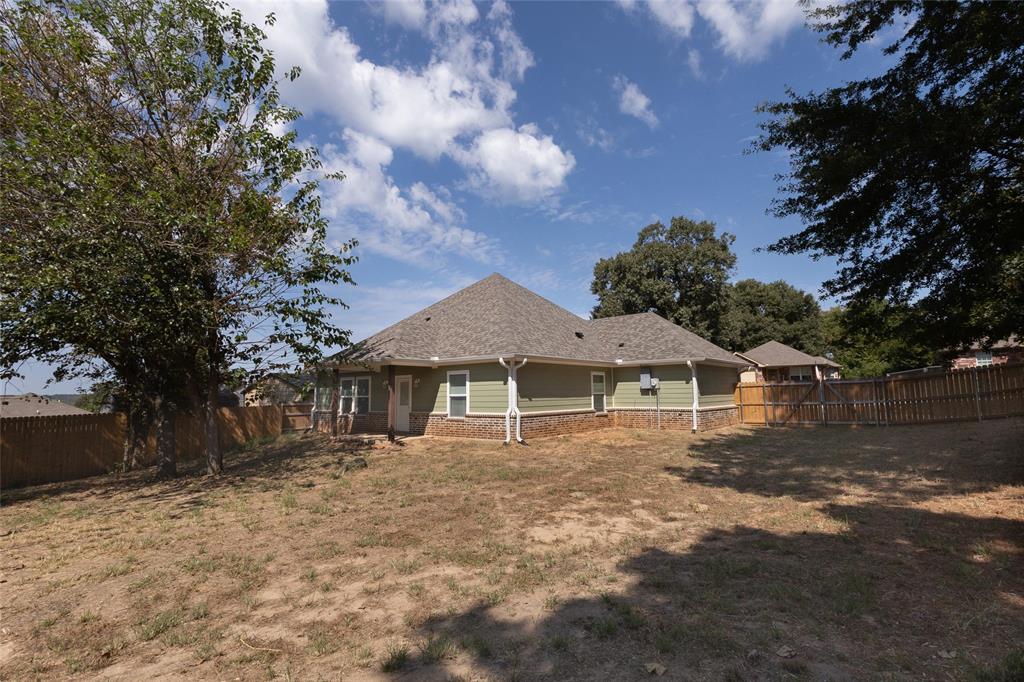 412 Crosby Street Lindale, TX 75771 - Photo 35 of 36 a white house that has a tree in front of it