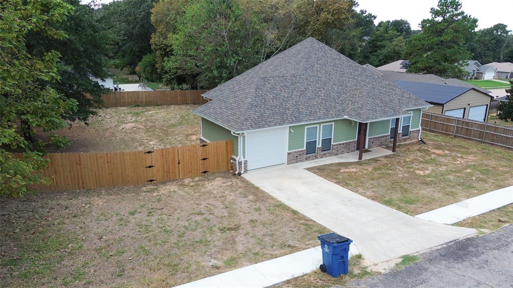 412 Crosby Street Lindale, TX 75771 - Photo 4 of 36 a house with trees in the background