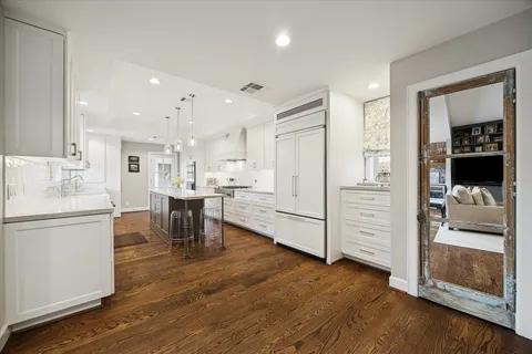 a open kitchen with white cabinets and stainless steel appliances