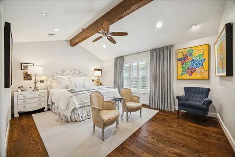 a bed room with furniture and painting on the wall