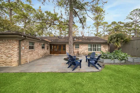 a front view of house with a garden and patio