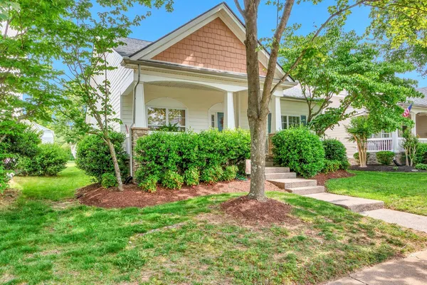 a front view of a house with a yard and an outdoor seating