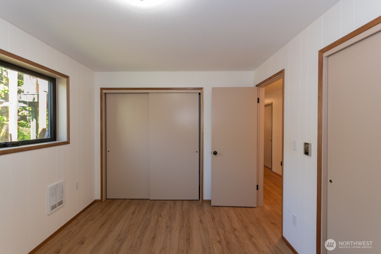 63 East Arnette Road Port Angeles, WA 98362 - Photo 25 of 40 a view of an empty room with wooden floor and a window