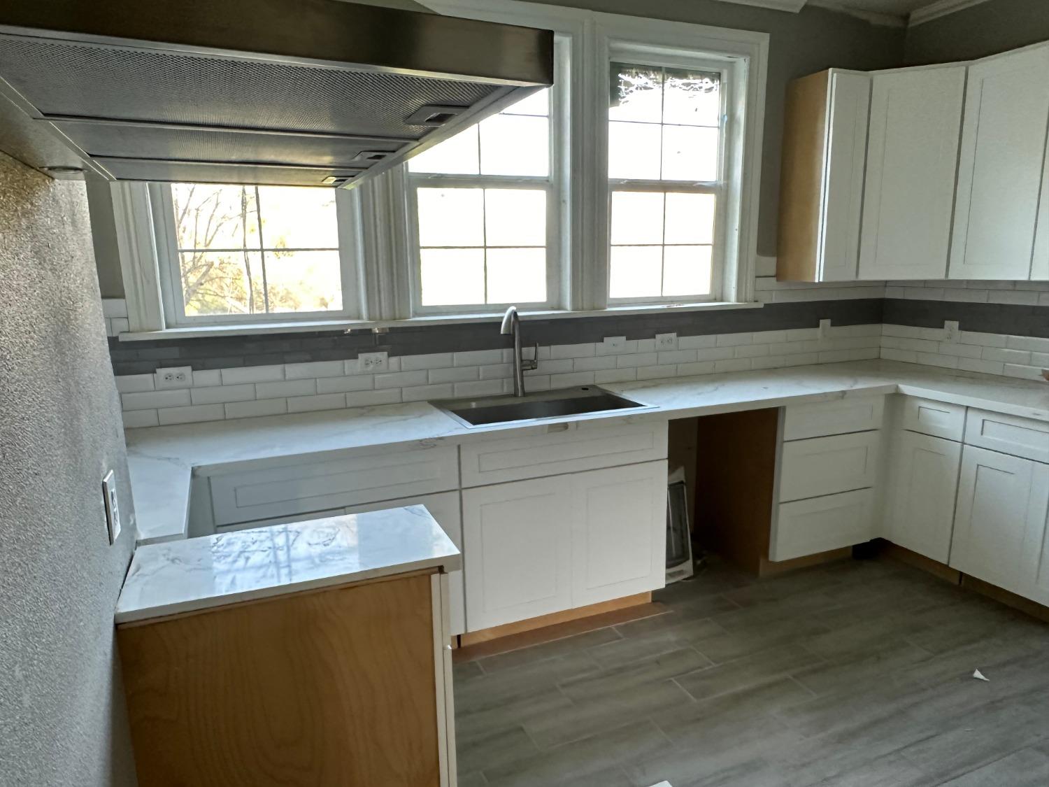 14055 River Road Walnut Grove, CA 95690 - Photo 22 of 55 a kitchen with a sink stove and cabinets