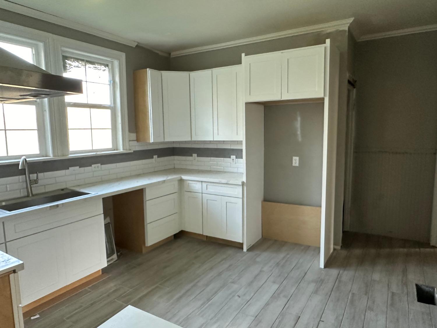 14055 River Road Walnut Grove, CA 95690 - Photo 23 of 55 a kitchen with a refrigerator sink and cabinets