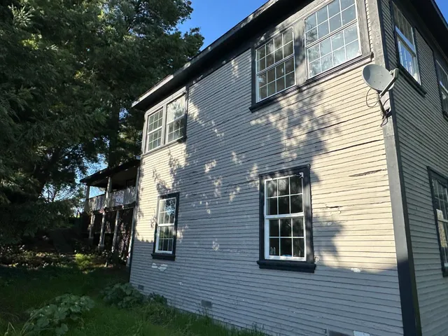 a view of backyard with barbeque and wooden stairs