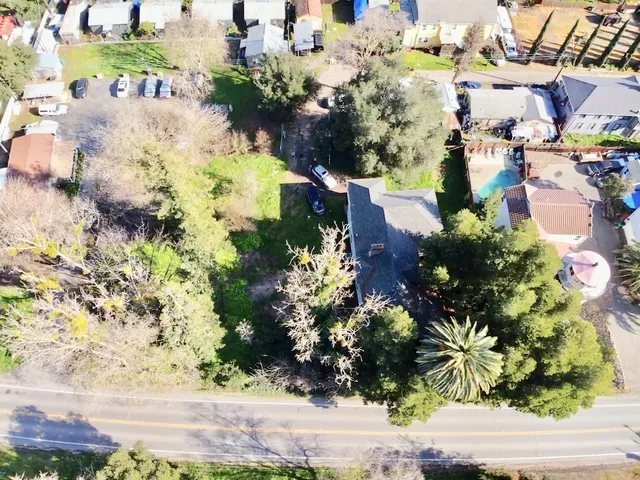 an aerial view of a houses with yard