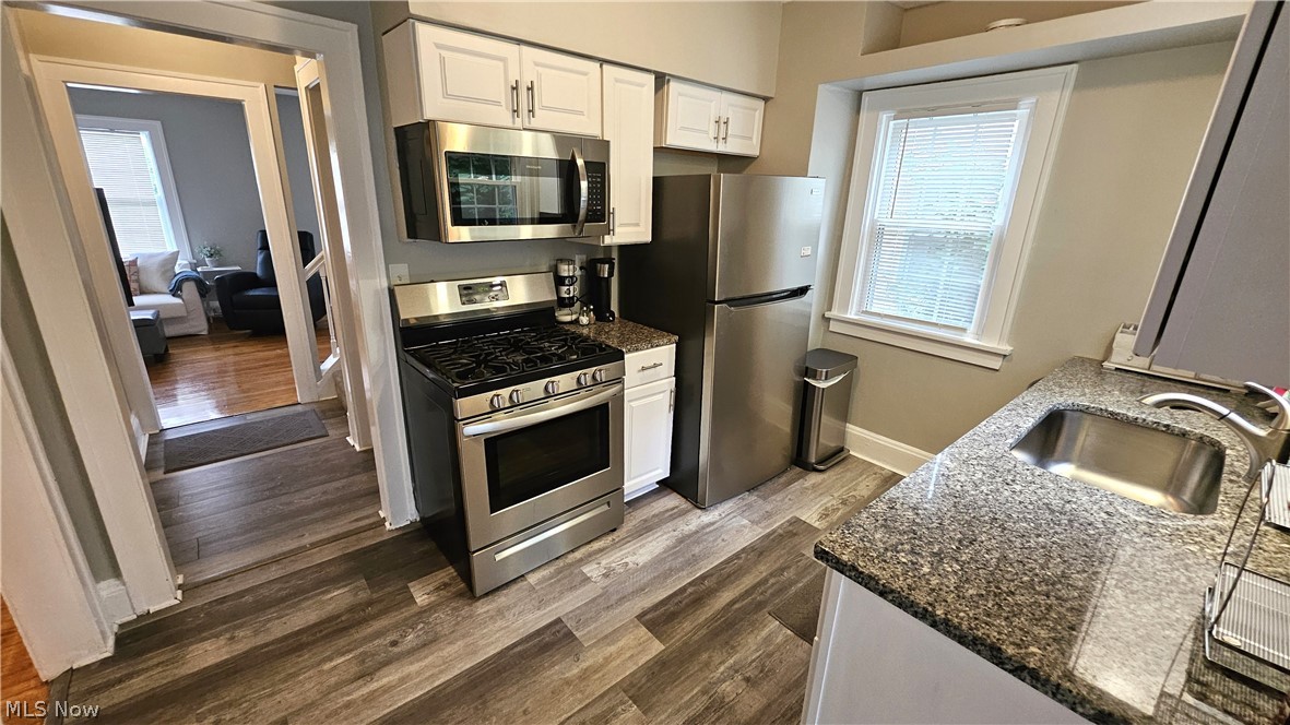 3576 Avalon Road Shaker Heights, OH 44120 - Photo 7 of 23 Updated kitchen features newer cabinetry, granite countertops, stainless appliances, and a tiled backsplash