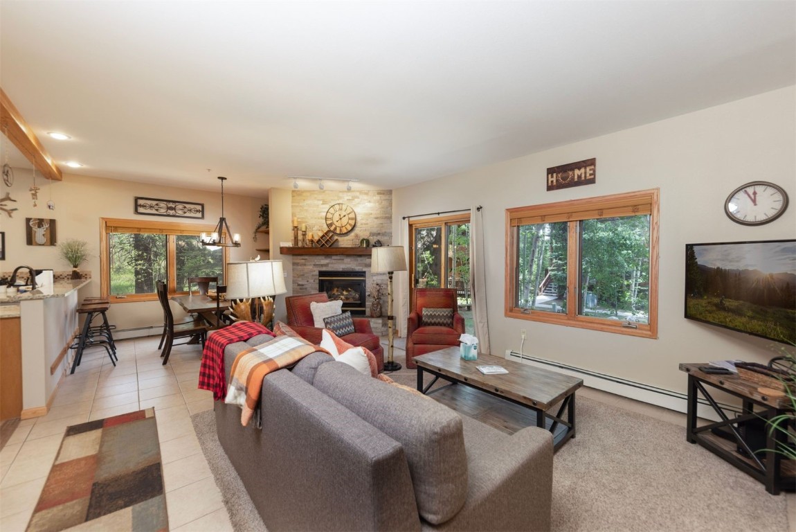 600 4 O Clock Road, Unit A11 Breckenridge, CO 80424 - Photo 5 of 22 a living room with furniture a window and a flat screen tv