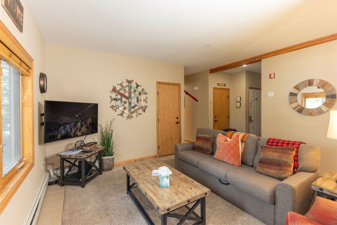 600 4 O Clock Road, Unit A11 Breckenridge, CO 80424 - Photo 8 of 22 a living room with furniture and a flat screen tv
