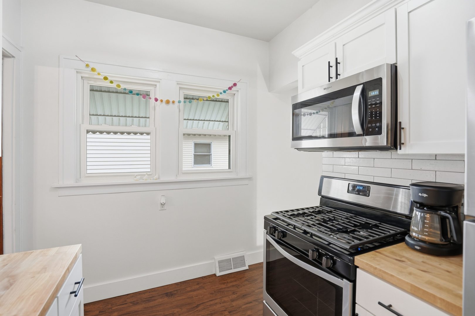 2431 14th Avenue Moline, IL 61265 - Photo 15 of 37 a kitchen with cabinets appliances and a window