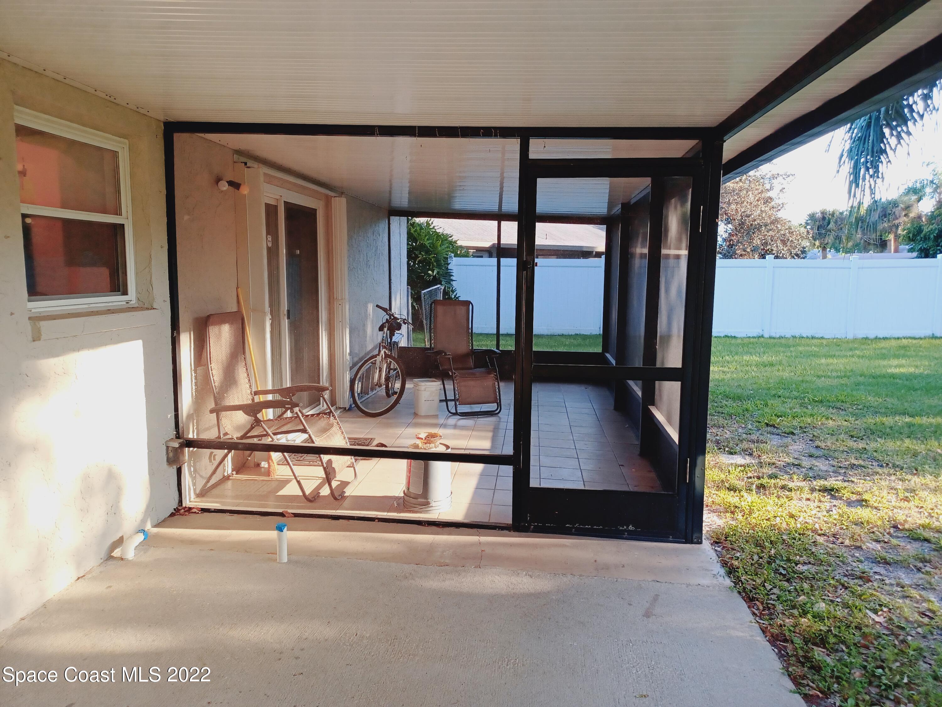 5480 Flint Road Cocoa, FL 32927 - Photo 12 of 20 a view of a living room and floor to ceiling window