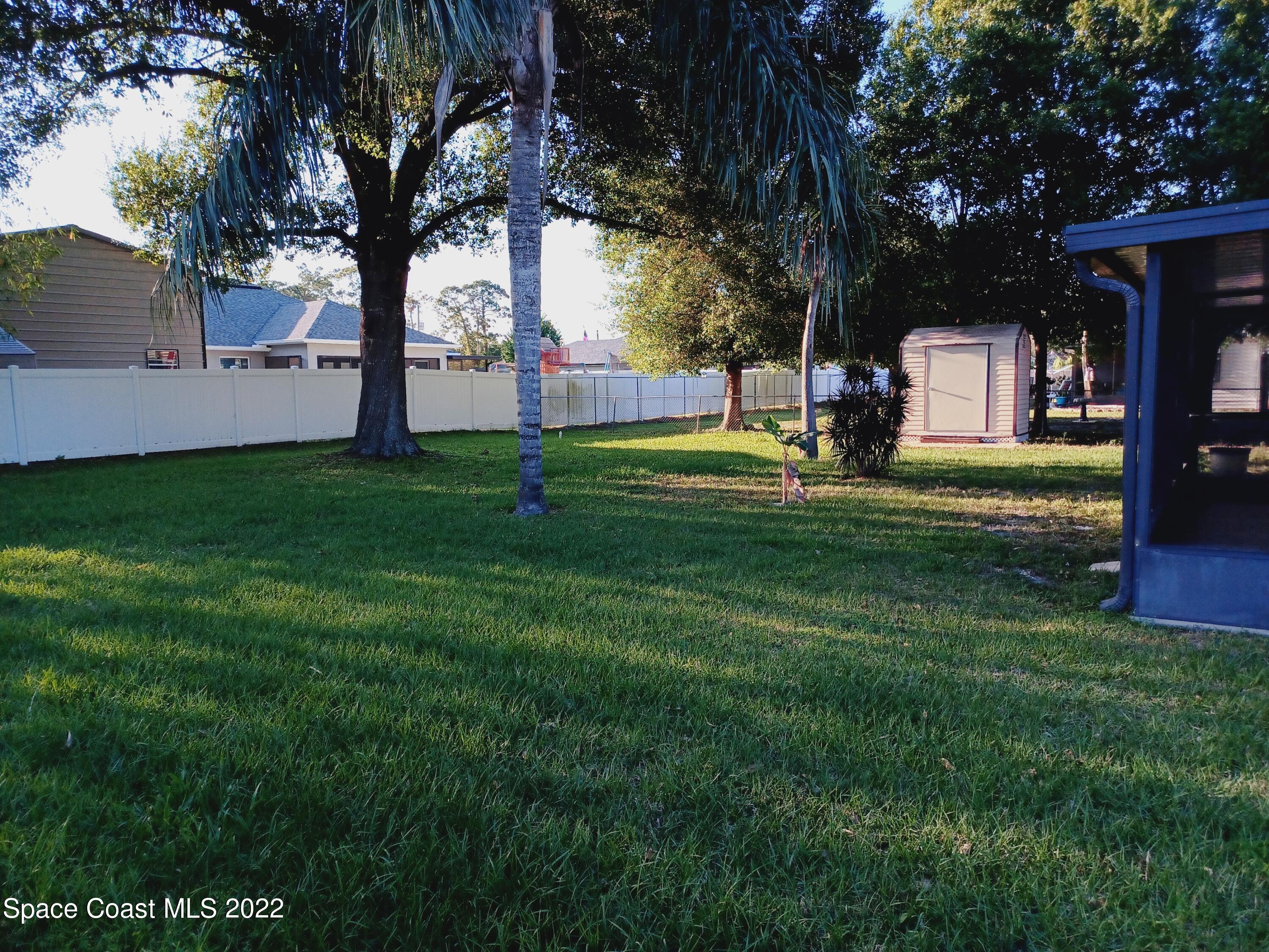 5480 Flint Road Cocoa, FL 32927 - Photo 13 of 20 a garden with trees in front of it