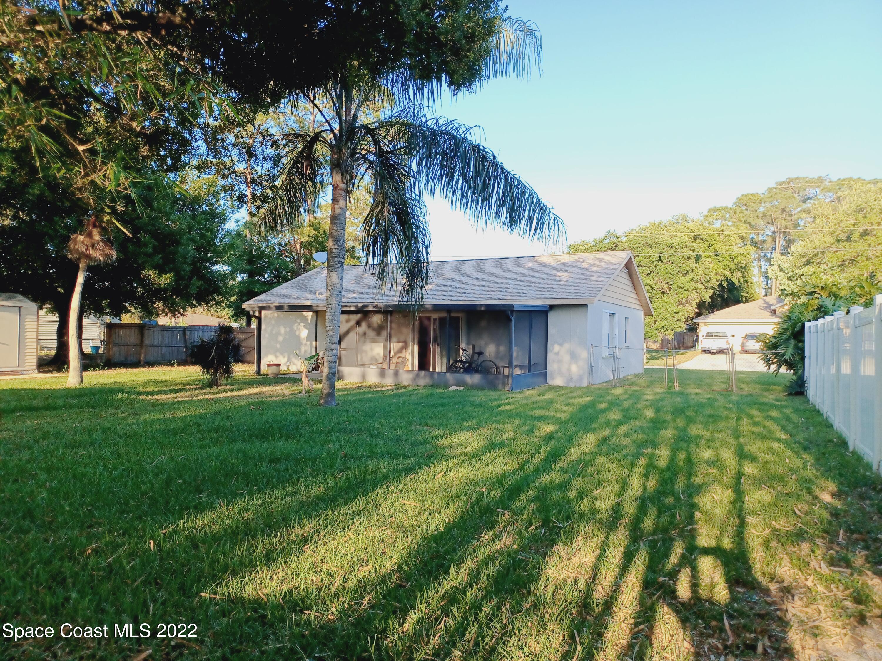 5480 Flint Road Cocoa, FL 32927 - Photo 14 of 20 a front view of a house with garden