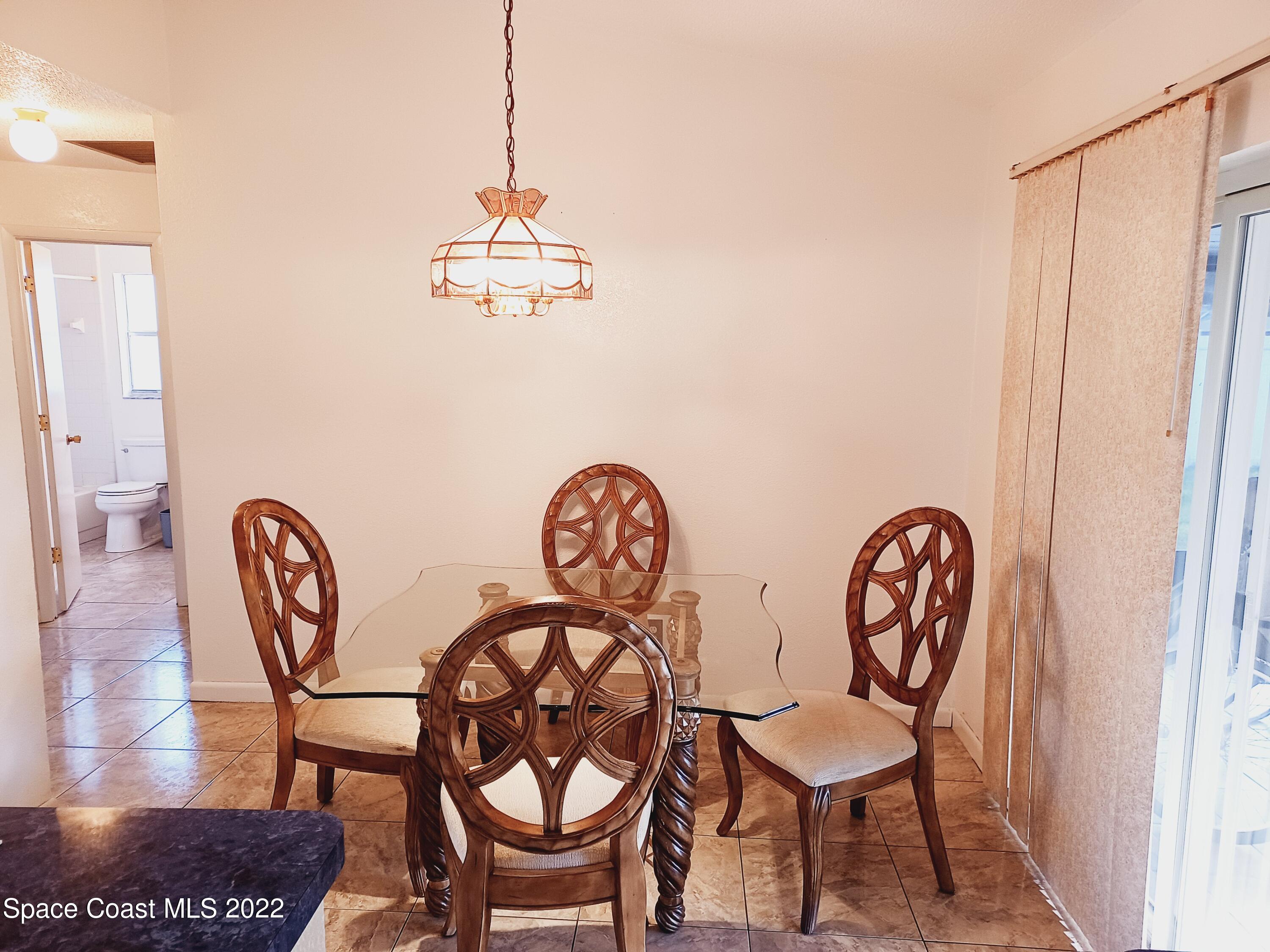 5480 Flint Road Cocoa, FL 32927 - Photo 3 of 20 a dining room with furniture and wooden floor