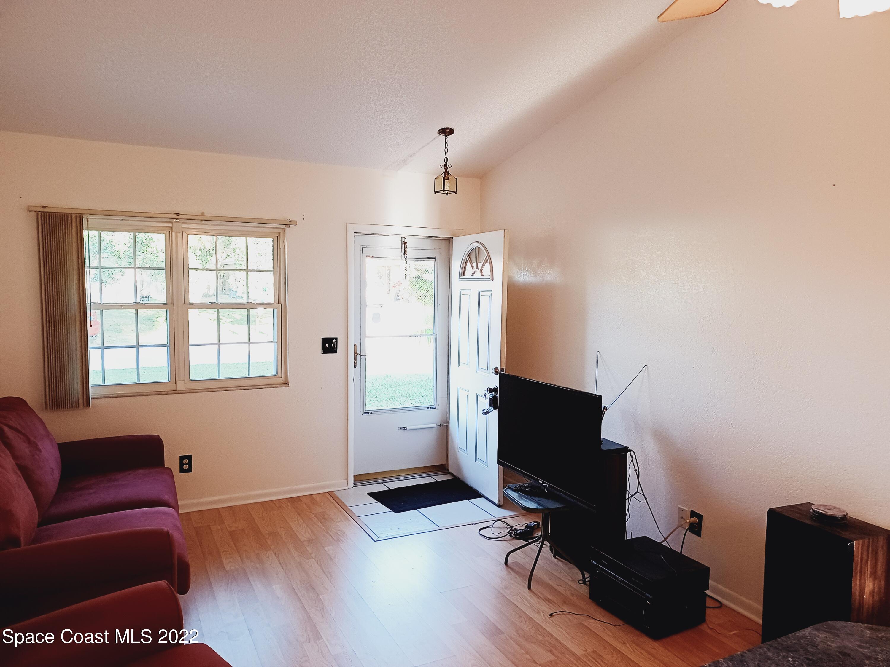 5480 Flint Road Cocoa, FL 32927 - Photo 5 of 20 a living room with furniture and wooden floor