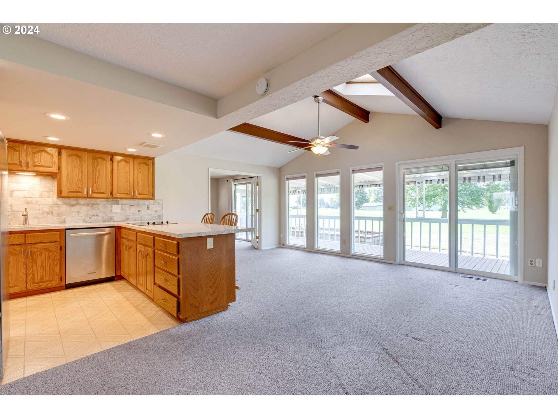 1585 Princeton Road Woodburn, OR 97071 - Photo 14 of 46 a large kitchen with kitchen island a large counter space a sink and appliances