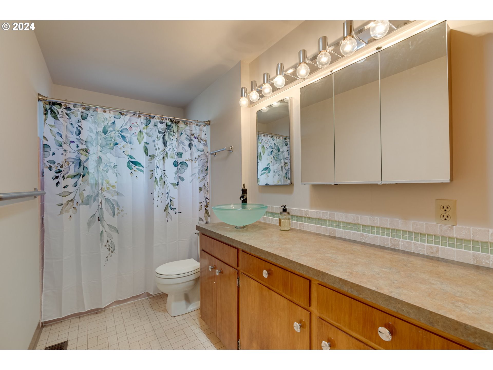 1585 Princeton Road Woodburn, OR 97071 - Photo 30 of 46 a bathroom with a granite countertop sink a toilet a mirror and shower curtain