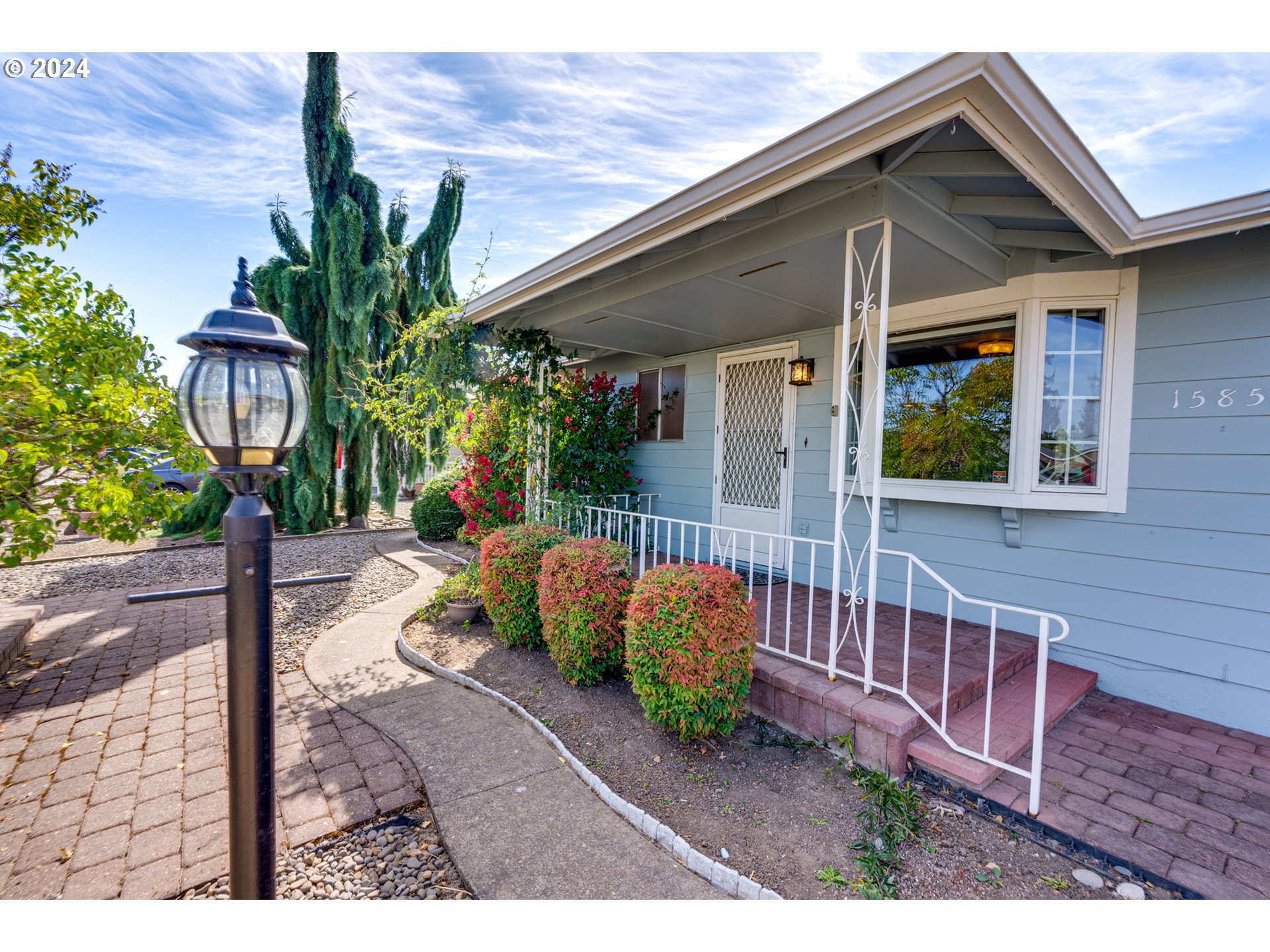 1585 Princeton Road Woodburn, OR 97071 - Photo 7 of 46 a view of a house with a small yard and plants