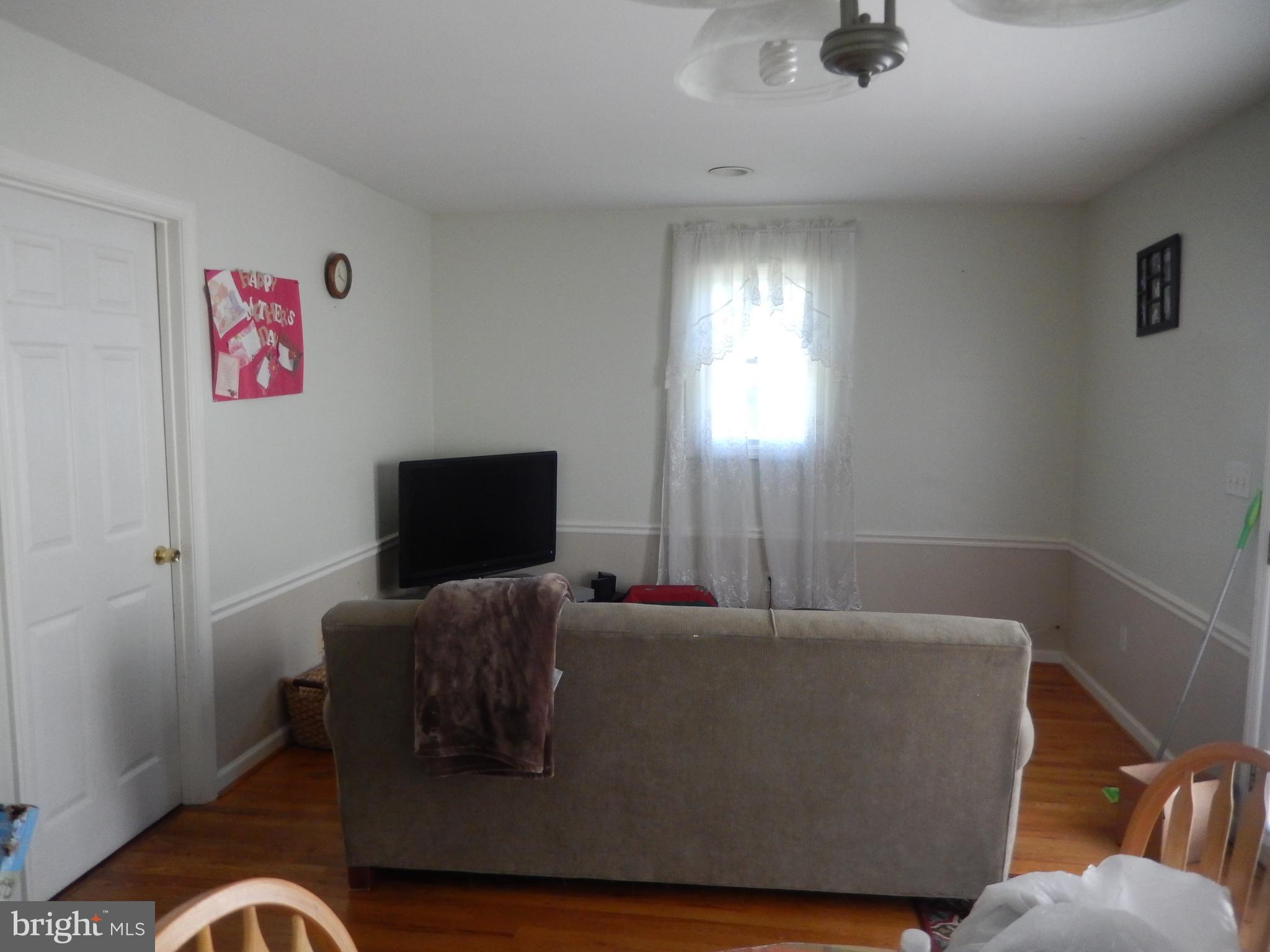 12210 Middle Road Silver Spring, MD 20906 - Photo 7 of 30 a living room with furniture and a flat screen tv