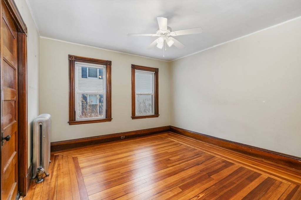 20-22 Florence Street Andover, MA 01810 - Photo 14 of 42 a view of an empty room with wooden floor and a window
