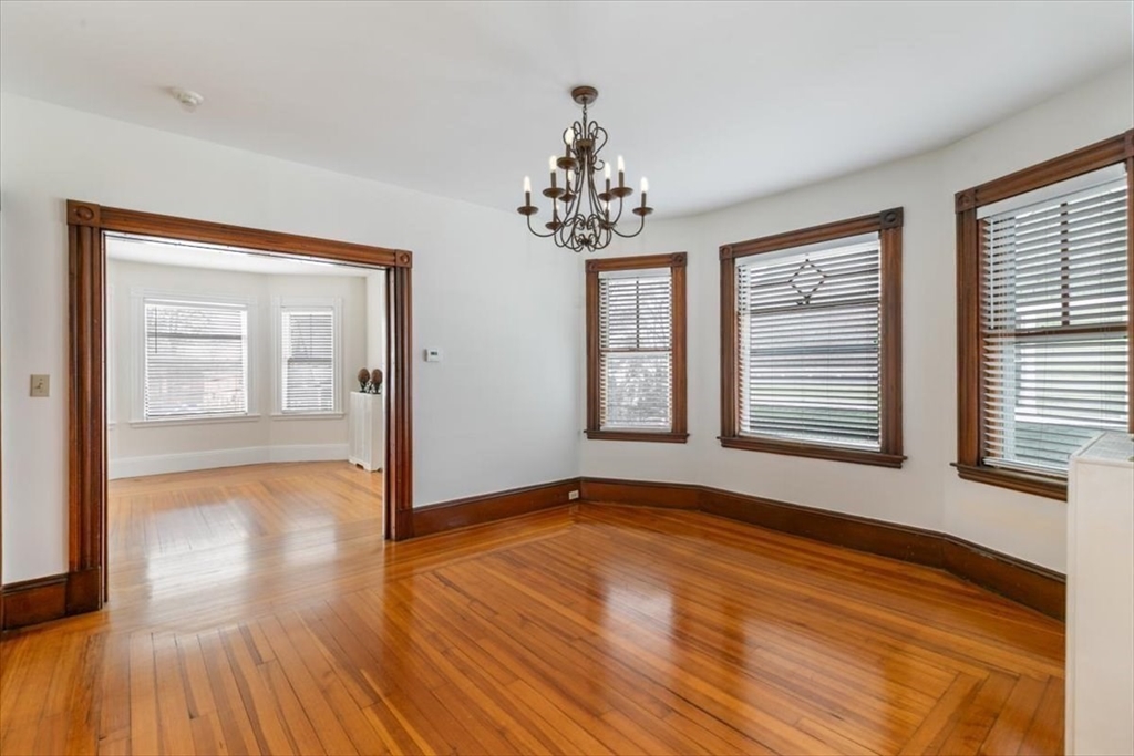 20-22 Florence Street Andover, MA 01810 - Photo 17 of 42 a view of an empty room with wooden floor and a window