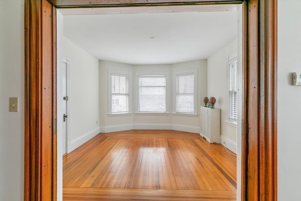 20-22 Florence Street Andover, MA 01810 - Photo 18 of 42 a view of an empty room with wooden floor and a window