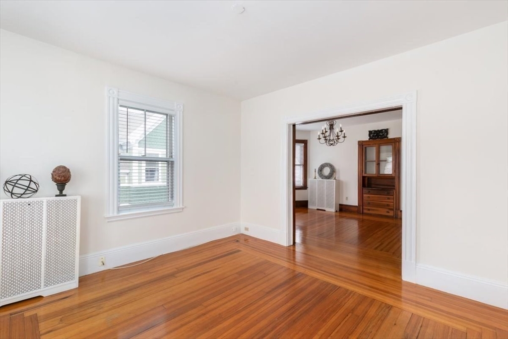 20-22 Florence Street Andover, MA 01810 - Photo 19 of 42 an empty room with wooden floor and mirror