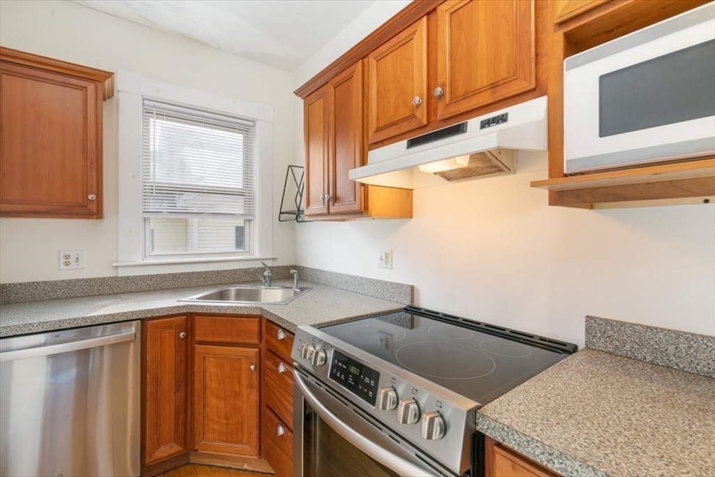 20-22 Florence Street Andover, MA 01810 - Photo 26 of 42 a kitchen with a sink cabinets and window