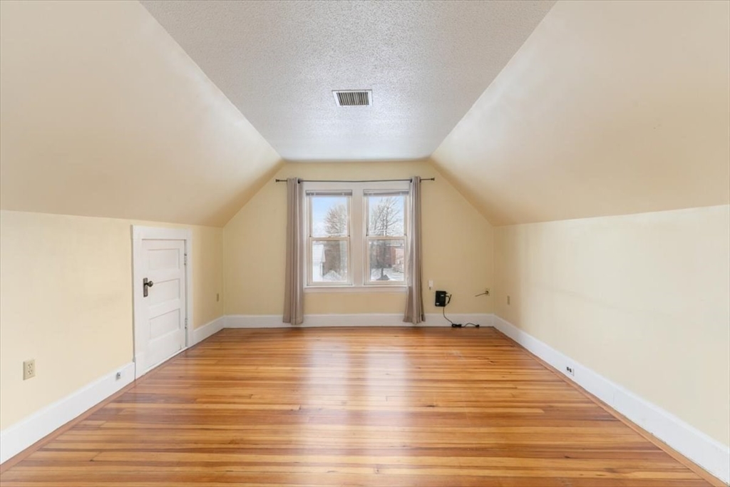 20-22 Florence Street Andover, MA 01810 - Photo 31 of 42 a view of an empty room with wooden floor and a window