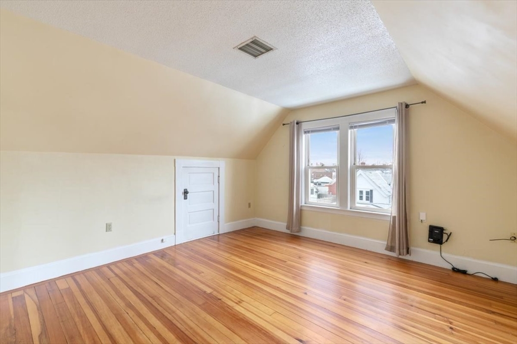 20-22 Florence Street Andover, MA 01810 - Photo 32 of 42 a view of empty room with wooden floor and fan