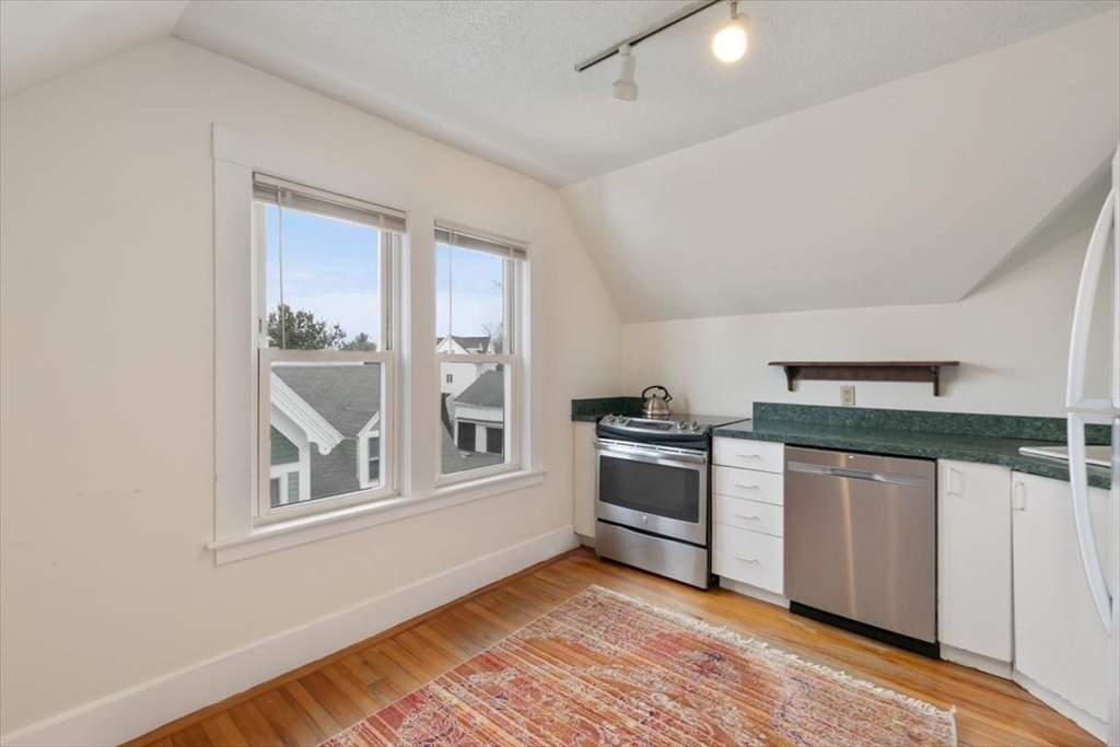 20-22 Florence Street Andover, MA 01810 - Photo 34 of 42 a kitchen with stainless steel appliances granite countertop a stove and a sink