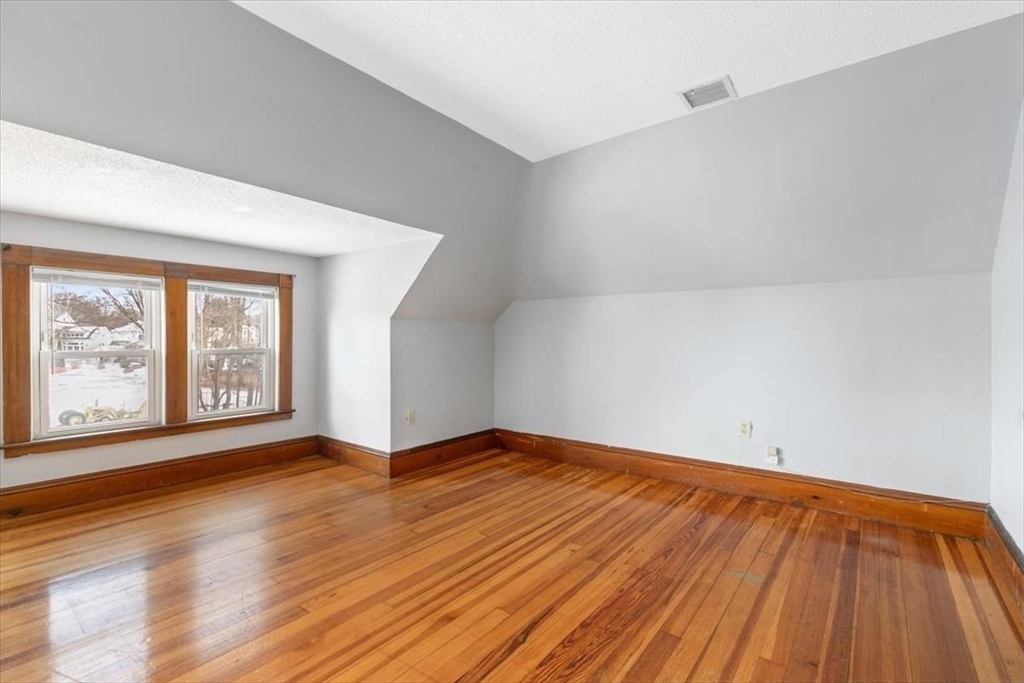 20-22 Florence Street Andover, MA 01810 - Photo 39 of 42 a view of an empty room with wooden floor and a window