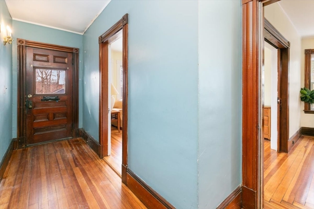 20-22 Florence Street Andover, MA 01810 - Photo 4 of 42 a view of a hallway with wooden floor and a bathroom