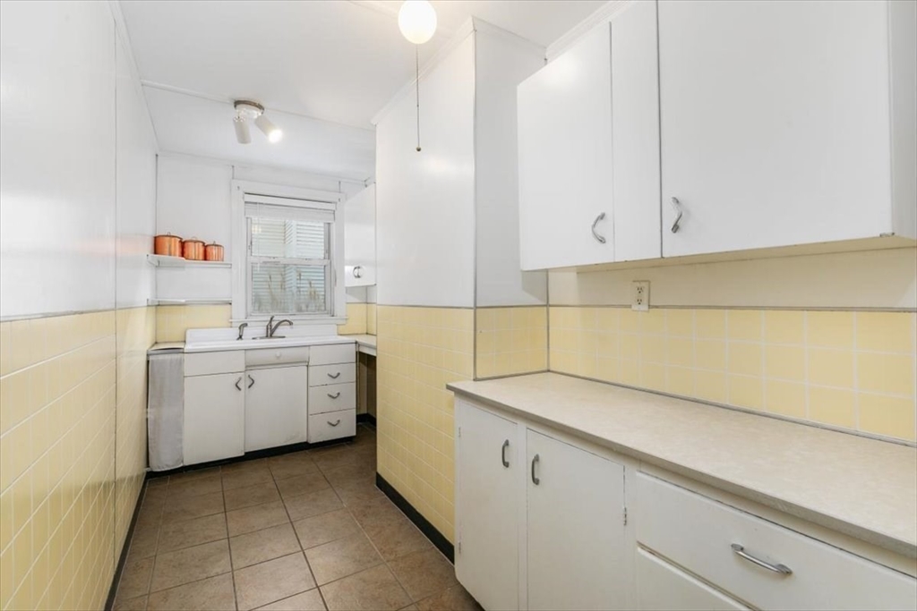 20-22 Florence Street Andover, MA 01810 - Photo 9 of 42 a utility room with cabinets washer and dryer