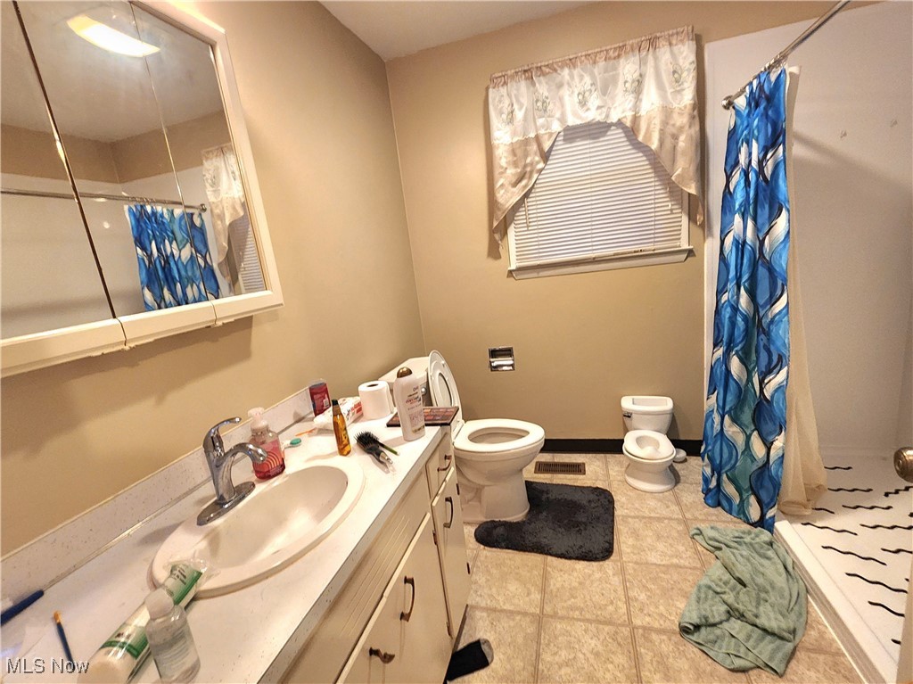 6280 Virginia Road Nashport, OH 43830 - Photo 12 of 14 Full bathroom with a shower with curtain, vanity, and light tile patterned floors