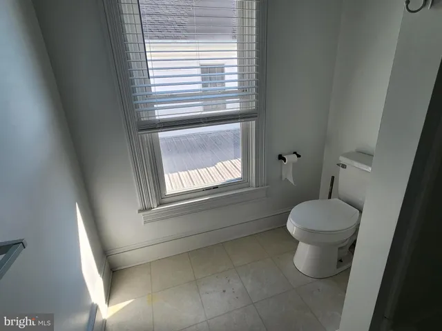 a bathroom with a toilet sink and window