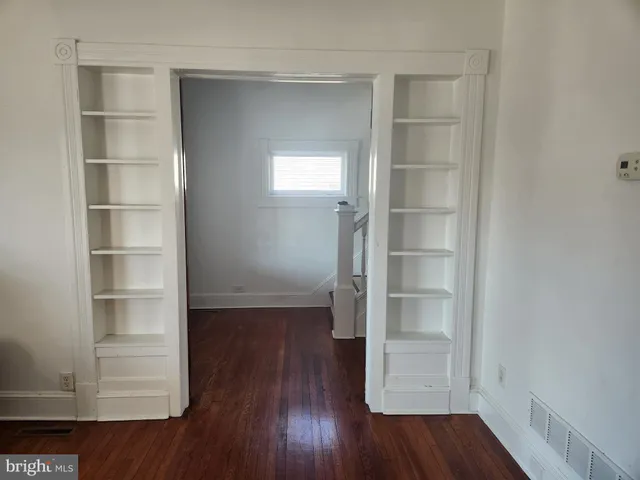 a view of walk in closet with empty racks