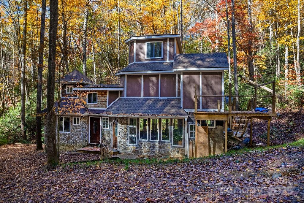 3761 Frozen Creek Road, Unit 31 32 33 Brevard, NC 28712 - Photo 14 of 25 a view of a brick house with large windows and a small yard