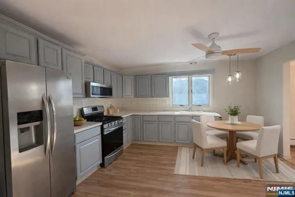 a kitchen with a sink cabinets and stainless steel appliances