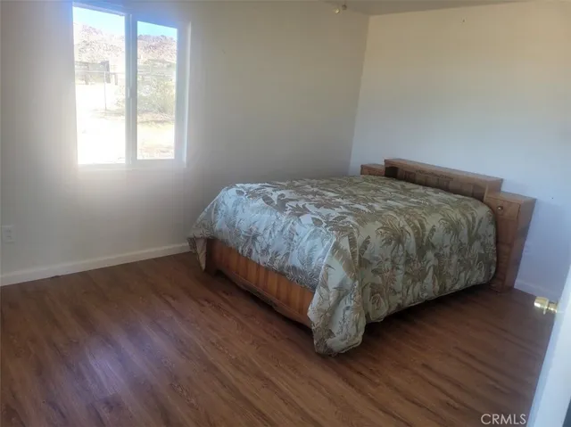a bed sitting in a bedroom next to a window