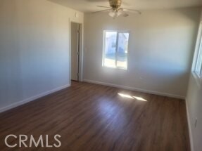 50471 Cholla Road Johnson Valley, CA 92285 - Photo 9 of 19 an empty room with wooden floor and windows